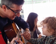 "Mr. Gabe" Hutter ’88 plays guitar for a young fan